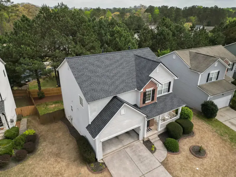 Two-story home with a new dark gray architectural shingle roof