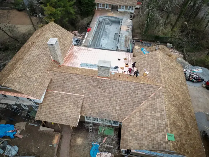 Cedar shake roof installation with copper flashing on a custom estate project