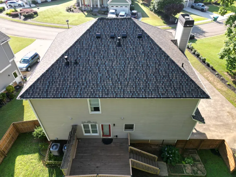 Drone view of a two-story hip-roof home in Holly Springs, GA with a new architectural shingle roof