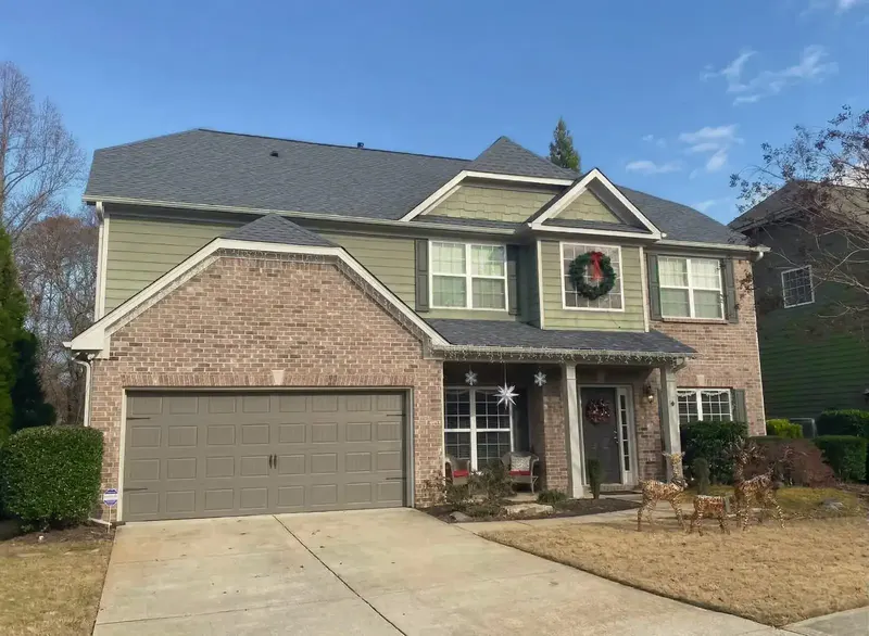 Completed roof replacement on two-story brick home in Harmony on the Lakes, Holly Springs