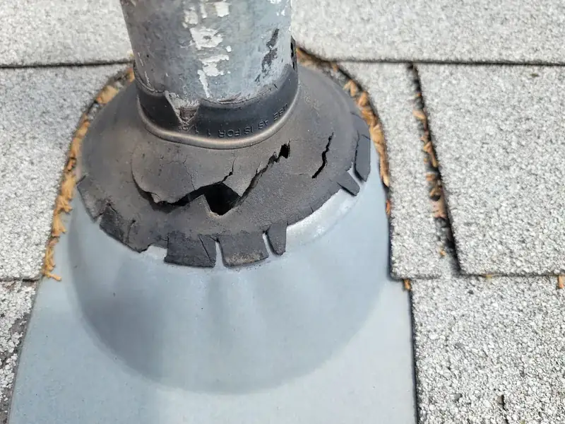 Cracked rubber pipe boot on aging Holly Springs roof