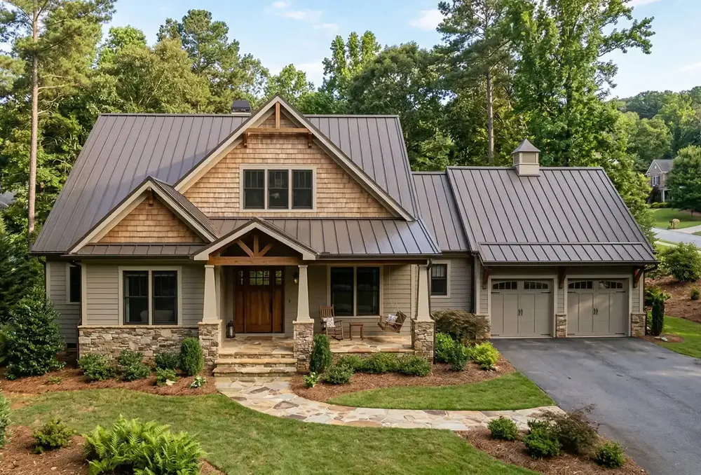 Bronze standing seam metal roof on a craftsman home with cedar shake accents